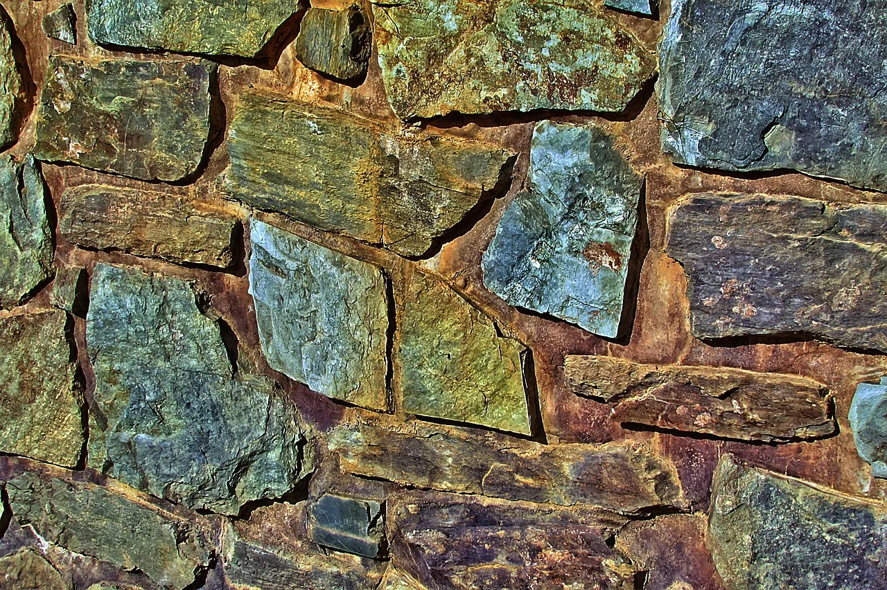 Ancient tufa walls wedged between modern apartment buildings in the Testaccio district of Rome