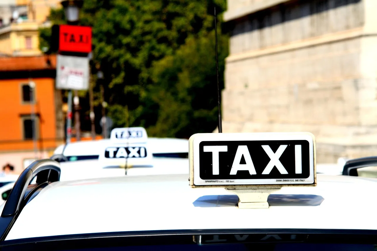 A white licensed Rome taxi with a roof sign parked beside an ancient brick city wall