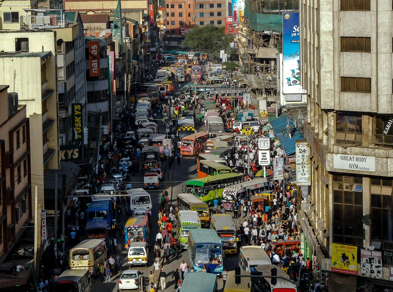 Minibuses lined up at a Nairobi matatu stage as passengers queue on the pavement
