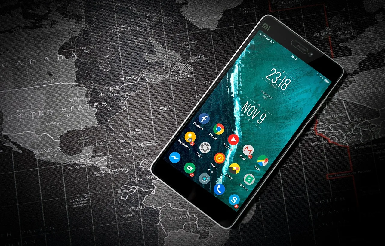 A smartphone on an aircraft tray table displaying an offline map with the aeroplane mode icon showing