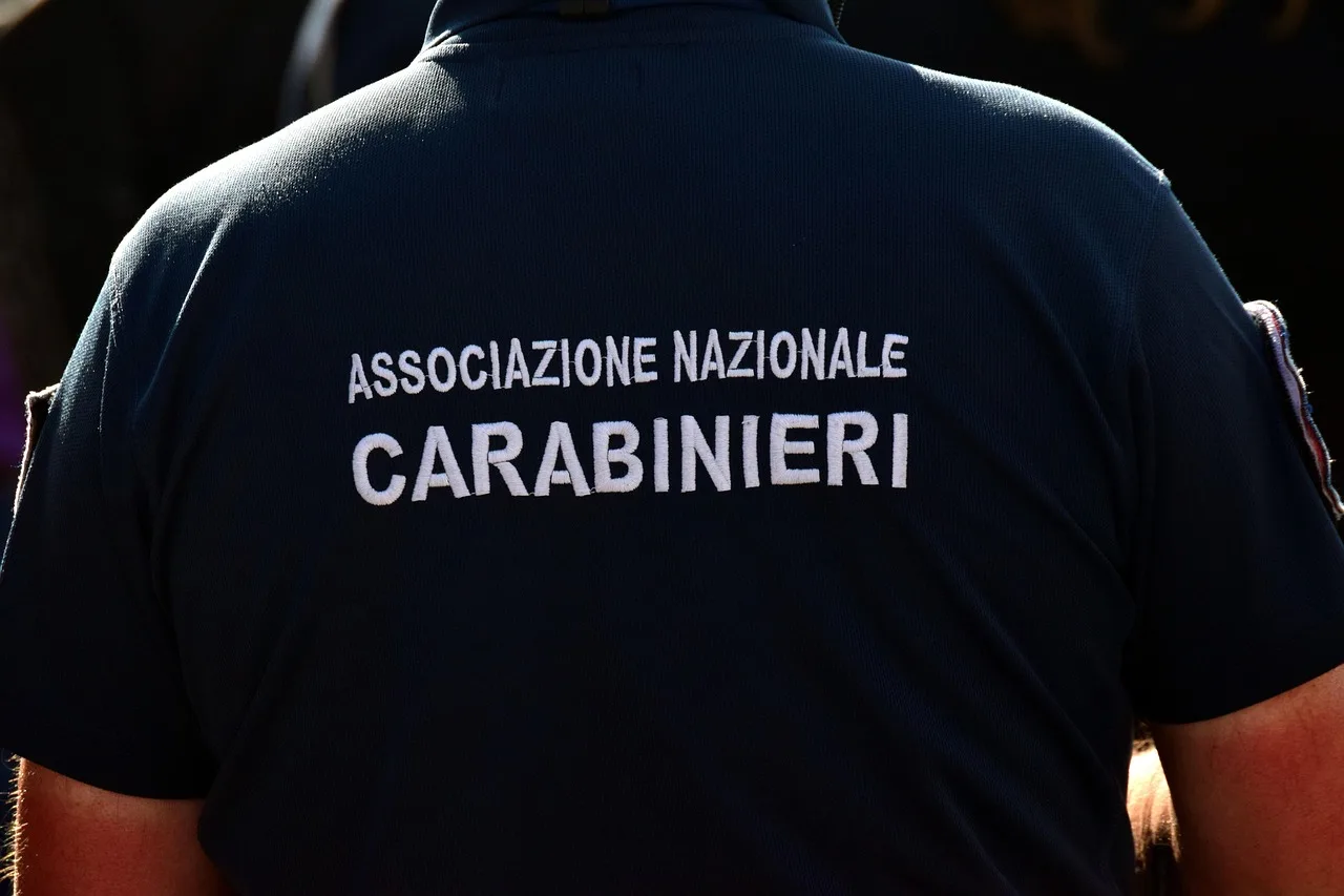 Two uniformed Italian police officers standing on a cobbled street in a city centre