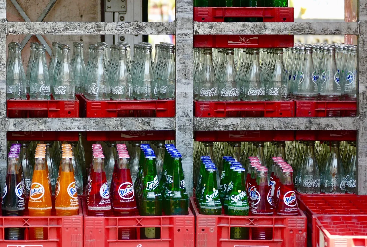 A supermarket deposit-return machine taking a plastic bottle and issuing a receipt