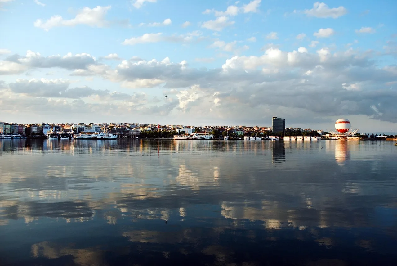 The small domed Moda pier building on its jetty over the Sea of Marmara, seen past waterfront chairs