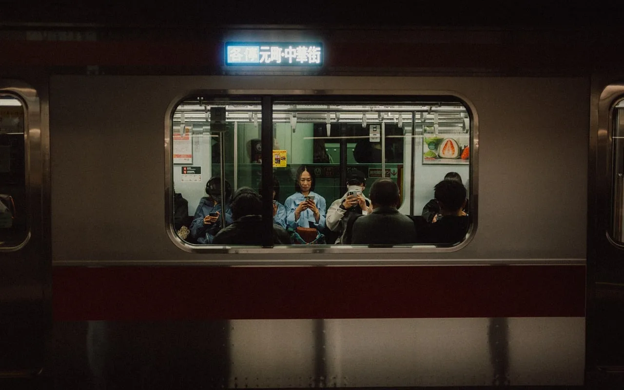 Passengers riding a subway escalator in Japan, standing on both the left and right sides of the steps