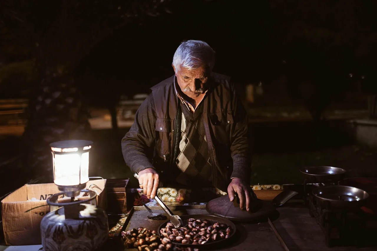 A market vendor uncovering her stall in the early morning before customers arrive